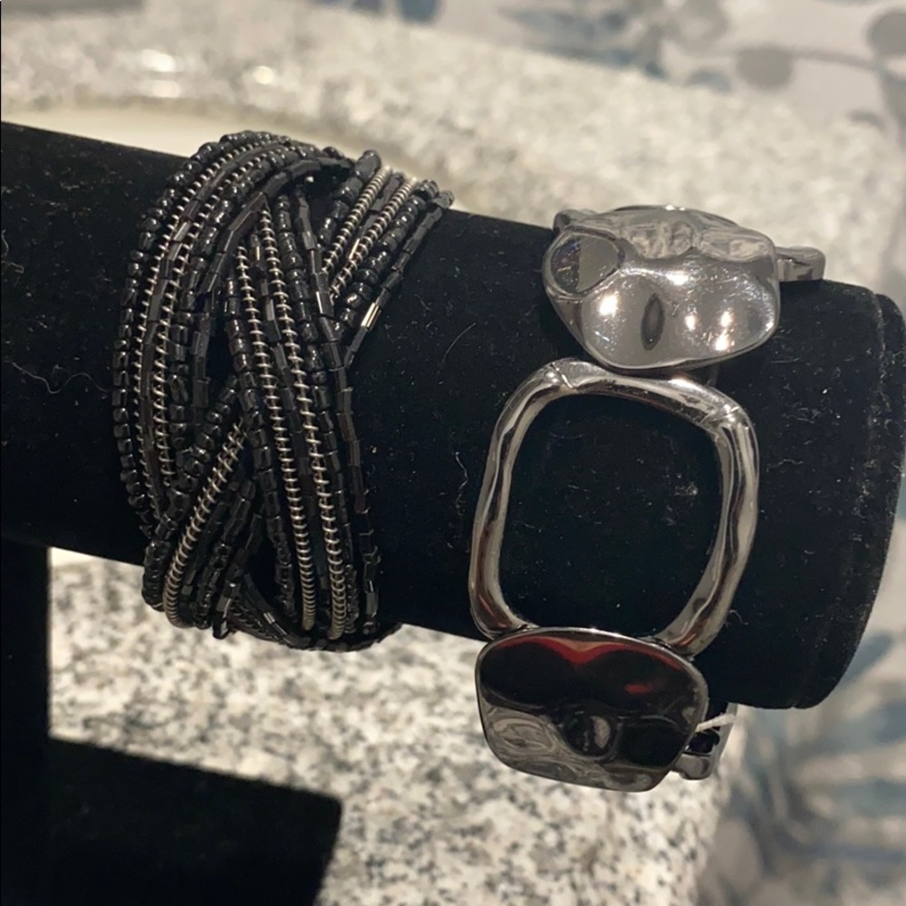 2 black/grey bracelets.